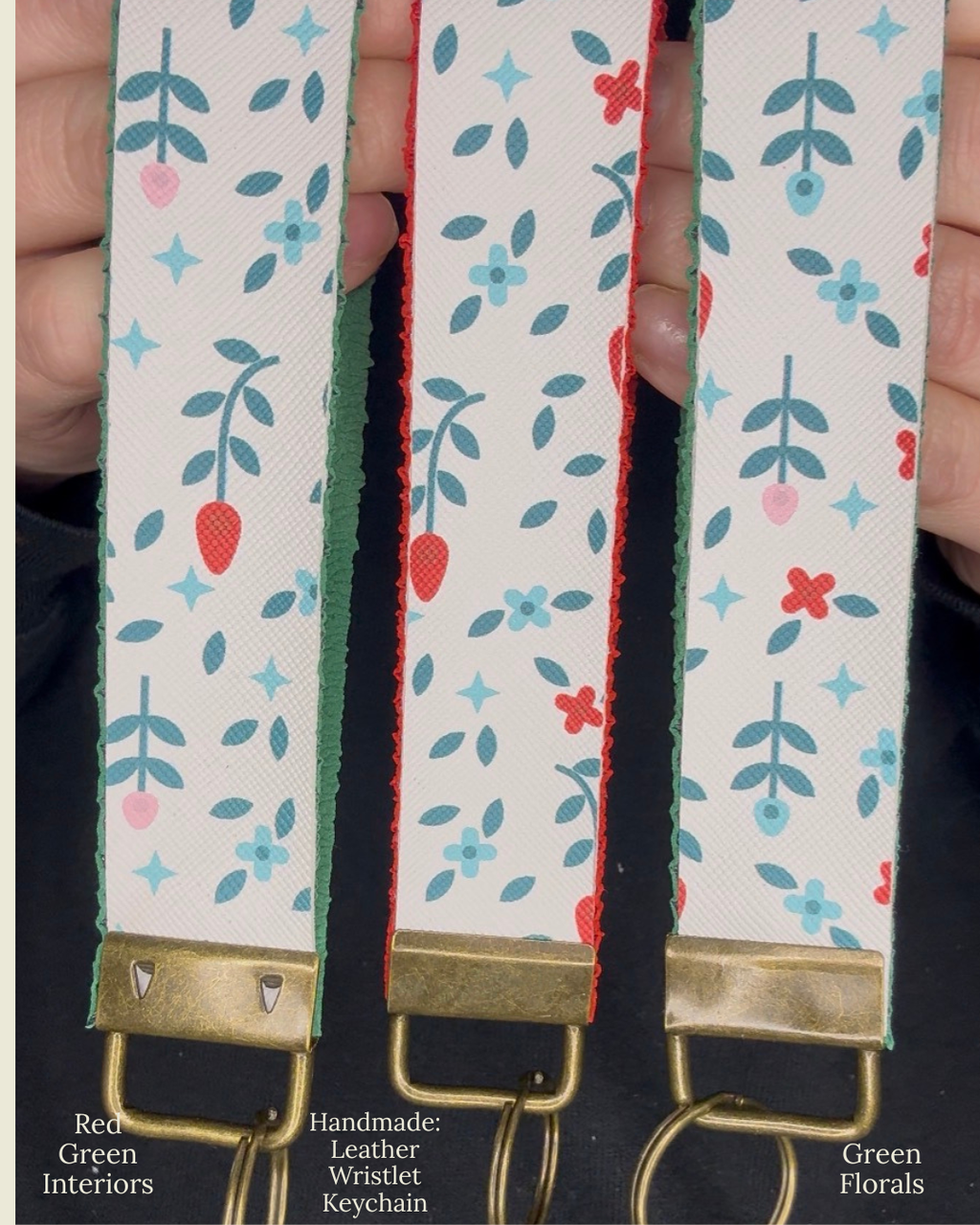 Three patterned straps with floral designs held by a hand, branded 'Red Green Interiors'.