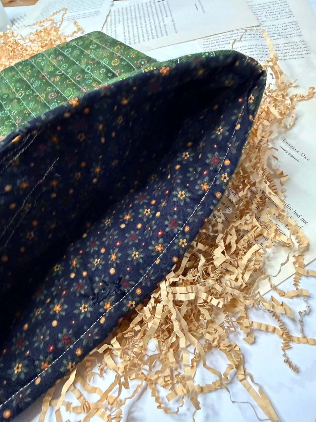 Close-up of a fabric pouch with floral pattern on a textured surface